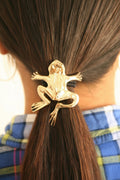 Gold frog ponytail hair hook securing ponytail, back view