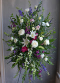 Standing spray in white and feminine jewel tones