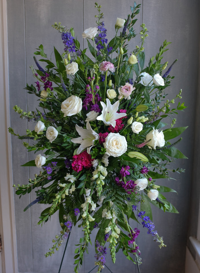 Standing spray in white and feminine jewel tones