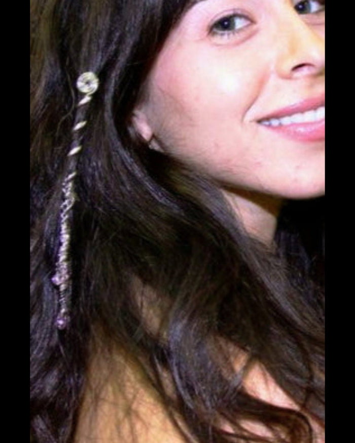 Model wearing a 2-inch silver Spiral Hair Twister with dangling charm in a small side ponytail.