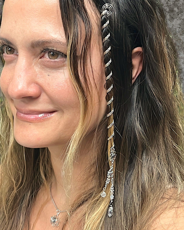 6 inch mini silver hair twister in long wavy blonde hair, spiral metal hair accessory with charm, styled in braid, side view