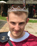 Model wearing Royal Crown silver wire headpiece, front view at a Renaissance faire.