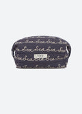 A navy blue quilted cosmetic pouch with an all-over beige script pattern reading 'Sea', featuring a small white brand label on the front.